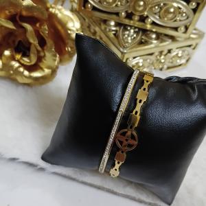 Gold-Toned Bangle Bracelet Featuring Embedded Crystals Line & A Charm Of Cross Floral Design