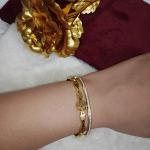 Gold-Toned Bangle Bracelet Featuring Embedded Crystals Line & A Charm Of Cross Floral Design